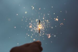 Hand holding lit sparkler
