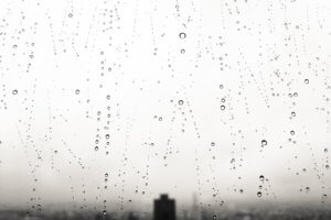 Water droplets on window with cityscape in background