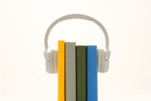 Four books standing up with headphones on top