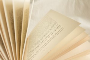 Close up of open book with white fabric background