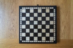 Black and white chess board on wooden surface