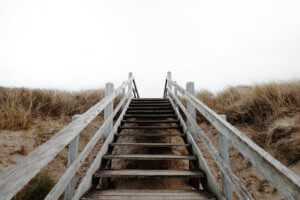 Wooden stairs leading up over sand dune