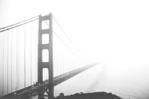 Greyscale of the Golden Gate bridge on a foggy day