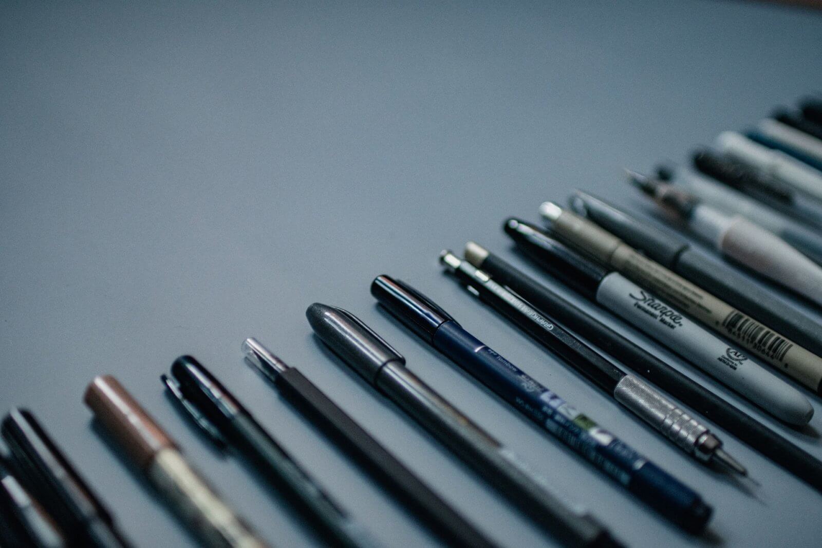Different kinds of pens lined up neatly